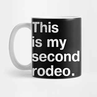 "This is my second rodeo." in plain white letters - cos you're not the noob, but barely Mug